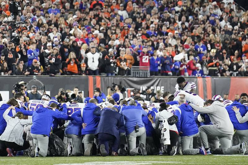Buffalo Bills players and staff pray for Buffalo defensive back Damar Hamlin during the first half game against the Cincinnati Bengals, Monday, Jan. 2, 2023, in Cincinnati. The game has been postponed after Buffalo Bills' Damar Hamlin collapsed, NFL Commissioner Roger Goodell announced.