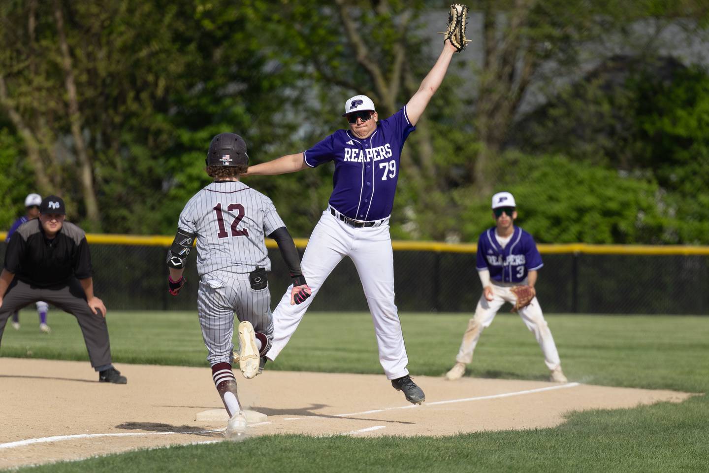 Plano first baseman Jackson Gates (79) stretches to catch a throw during Wednesday's game in Plano.