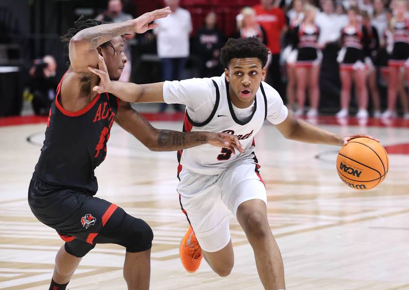 Benet's Perry Tchiegne Wandji works against Auburn's Amir Danforth Monday, March 9, 2026, during their IHSA Class 4A supersectional matchup in the Convocation Center at Northern Illinois University in DeKalb.