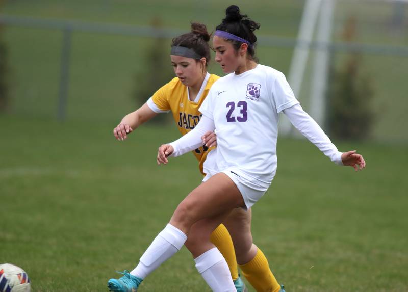 Jacobs’  Ava Nisi, back, races Hampshire’s Naieli Juarez for the ball in varsity girls soccer on Thursday, April 17, 2025, at Jacobs High School in Algonquin.