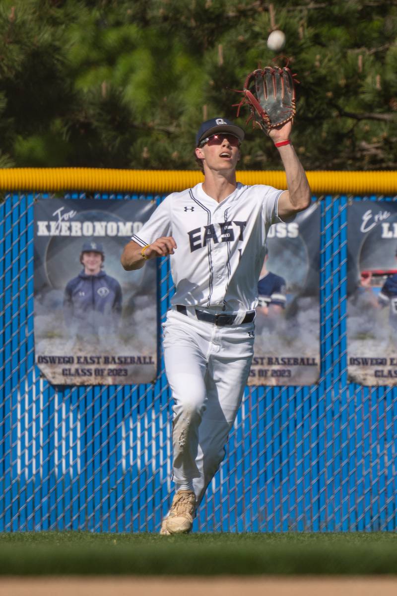 Oswego East's Michael Polubinski (1) plays a fly-ball for an out against Oswego during a baseball game at Oswego East High School on Wednesday, May 10, 2023.