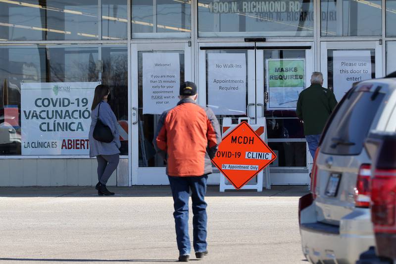 People head inside a McHenry County Department of Health COVID-19 vaccination clinic at 1900 N. Richmond Road, the former site of a Kmart in McHenry, on Tuesday, March 2, 2021.  Vaccinations are made by appointment only.