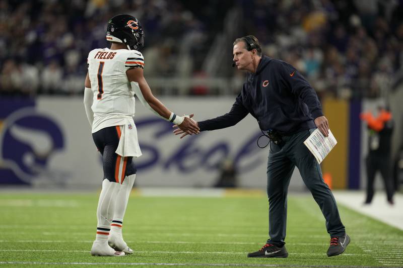 Chicago Bears head coach Matt Eberflus greets quarterback Justin Fields as he walks off the field during the first half against the Minnesota Vikings, Monday, Nov. 27, 2023, in Minneapolis.