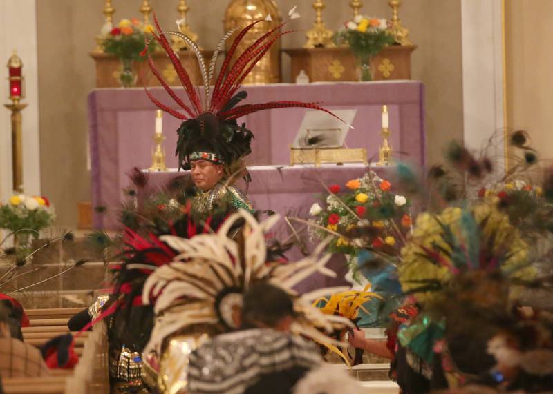 Javier Bucio wears a head dress during the Lady of Guadalupe event on Tuesday, Dec. 12, 2023 at St. Hyacinth Church in La Salle. Our Lady of Guadalupe, also known as the Virgin of Guadalupe, is a Catholic title of Mary, mother of Jesus.