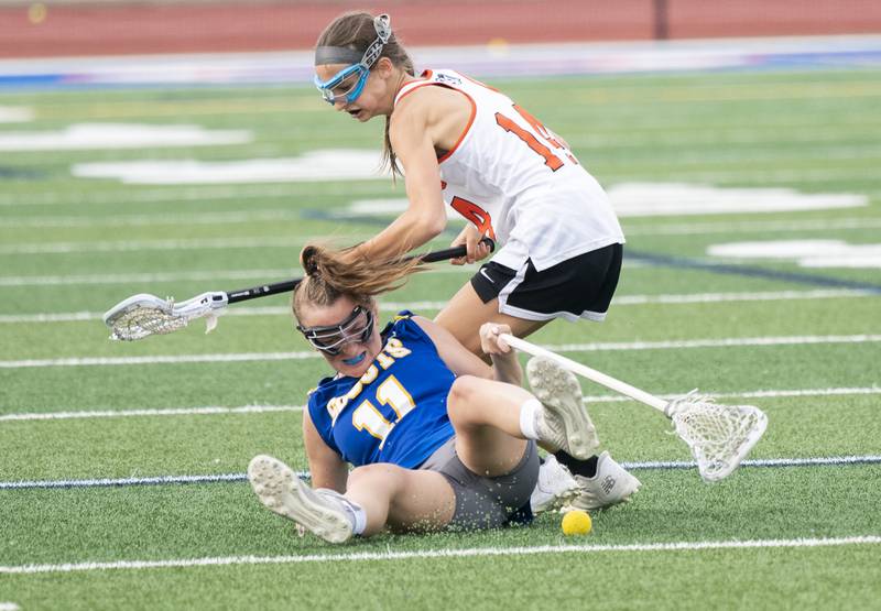 Crystal Lake Central Co-Op's Addison Bechler battles for a loose ball with Lake Forest's Carly Kisselle, 11, during the girls lacrosse supersectional match on Tuesday, May 31, 2022 at Hoffman Estates High School.