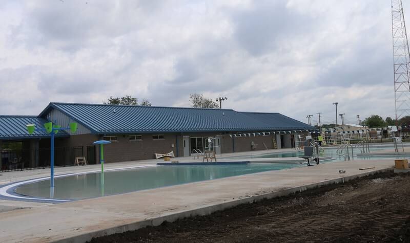 Workers move dirt to landscape behind Riordan Pool on Tuesday, June 13, 2023 in Ottawa. The pool will open June 19 to the public. The construction of the 6.7 million dollar pool began in September of 2022. The facility includes a 9,700 square foot pool, complete with a zero foot entry, six 70-foot competition lanes and three diving stands, plus a 5,700 square foot building containing private family changing rooms, locker rooms, showers, restrooms and offices.
There will be a shelter with picnic tables, vending machines and tables for umbrellas.