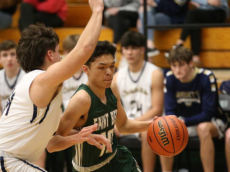 St. Bede's Isaiah Hart runs around Marquette's Alex Graham into the paint in the Class 1A Regional semifinal on Wednesday, Feb. 22, 2023 at Midland High School.