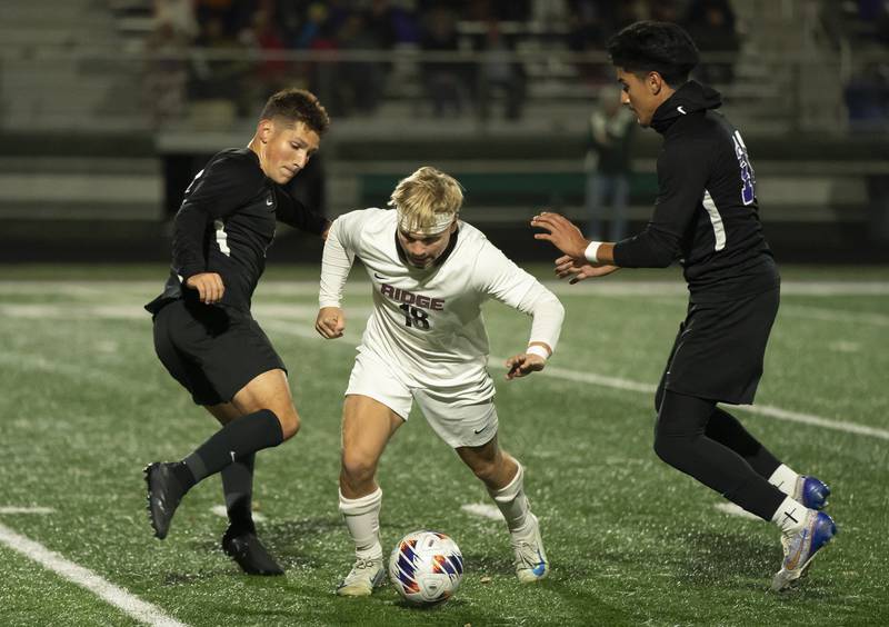 Prairie Ridge's Gabriel Porter controls the ball between Wauconda's Luka Gmitrovic, left, and Mario Torres during the Class 2A Boys Soccer Sectional final on Friday, November 1, 2024 at Grayslake Central High School. Ryan Rayburn for Shaw Local