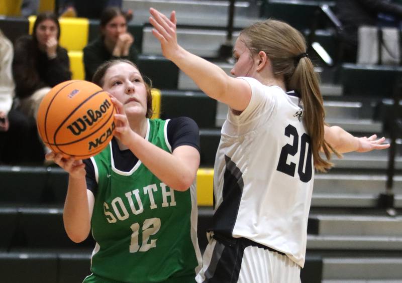 Crystal Lake South’s Gaby Dzik, left, shoots as Kaneland’s Samantha Kerry defends in IHSA Class 3A Regional Title Game girls basketball action on Friday, Feb. 21, 2025, at Crystal Lake South High School in Crystal Lake.
