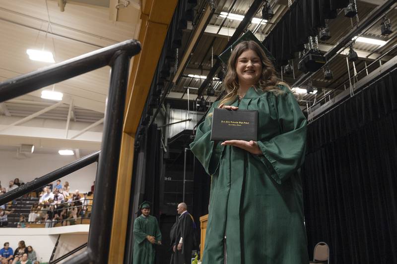 Kennedy Adams stops to show off her diploma Sunday, May 18, 2025, during Rock Falls High School’s 2025 commencement.