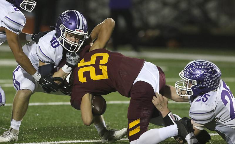 Rochelle's Ethan Goodwin (left) and Brock Metzger tackles Richmond-Burton's Ryan Saranzak during a Kishwaukee River Conference football game on Friday, Oct.20, 2023, at Richmond-Burton High School.