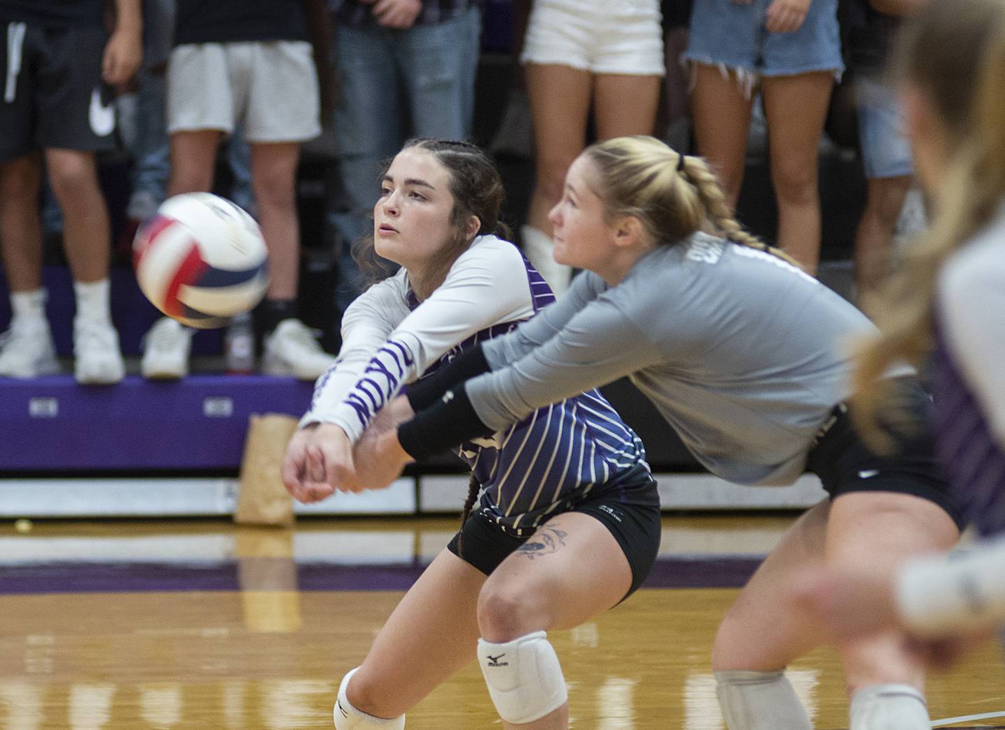 Dixon’s Joey Brumbly and Natalie Davidson come together while playing a shot against Alleman on Wednesday, Sept. 7, 2022.