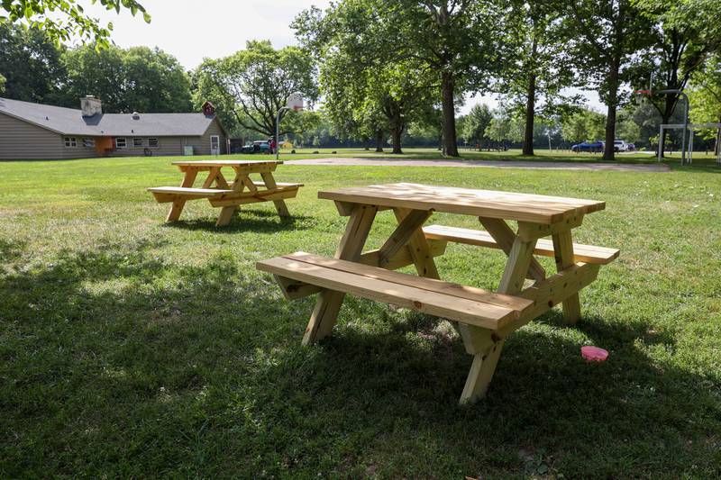Finished picnic tables built by a recent Tool Time group at Camp Shaw-Waw-Nas-See are in use near the camp office on Wednesday, July 16, 2025,