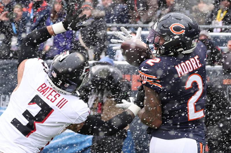 Chicago Bears wide receiver DJ Moore catches a touchdown pass behind Atlanta Falcons safety Jessie Bates III during their game Sunday, Dec. 31, 2023, at Soldier Field in Chicago.