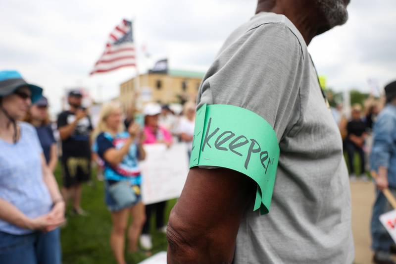 A volunteer wears an arm band that reads "Peace keeper" as approximately 500 people gathered at the Kankakee County Courthouse for a ‘No Kings’ rally in Kankakee on Saturday, June 14, 2025, to protest actions by President Donald Trump.