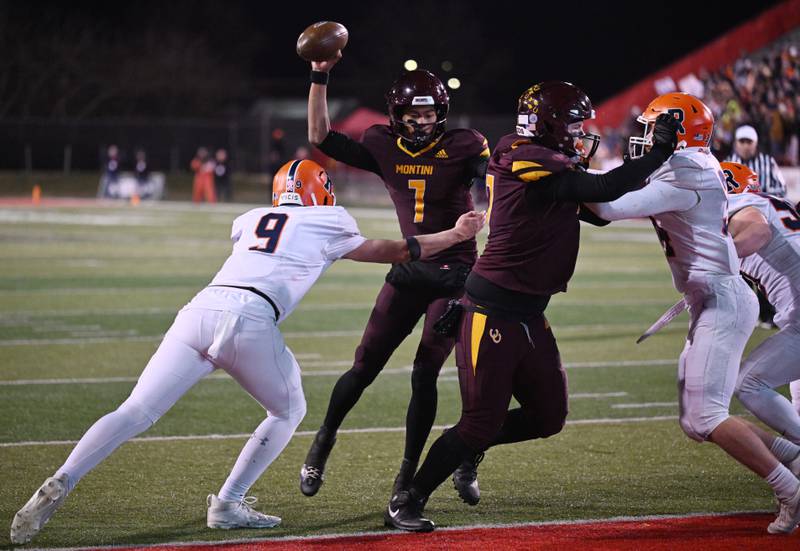 Montini quarterback Israel Abrams (7) side steps Rochester's Tanner Beal as he scores a touchdown during the IHSA Class 4A state championship game on Friday, Nov. 28, 2025 in Normal.