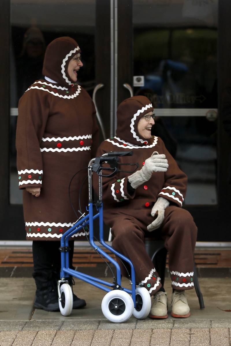 Diana Kenney  and Bob Blazier watch the start of the McHenry County Santa Run For Kids on Sunday morning, Dec. 3, 2023, in Downtown Crystal Lake. The annual event raises money for agencies in our county who work with children in need.