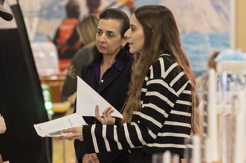 Lupita (left) and Carolina Bonnell of Mexicali Rose banquet hall in Rock Falls speak with customers Sunday, Feb. 2, 2025, at the Sauk Valley Wedding Expo in Sterling.