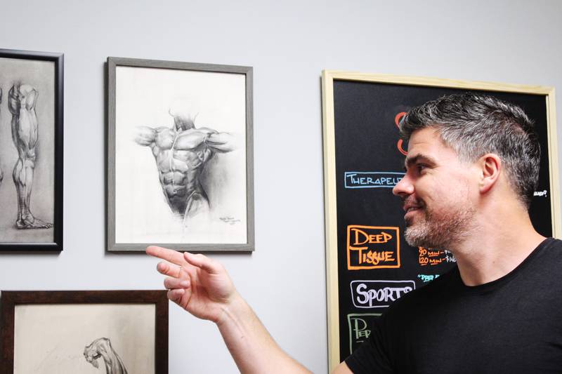 Dixon artist Ryan Jandrey points of some of his anatomic drawings on March 23, 2026 at his Bodyworx studio in Sterling.
