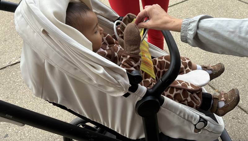 Fernanda Moraza, 1, of Woodstock receives a piece of candy at Anime and Things during Halloween on the Square in Woodstock Oct. 31, 2025.