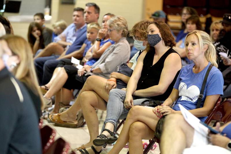 Parents in support of students wearing masks and parents supporting a choice to wear masks this school year attend a Geneva Community Unit School District 304 meeting at Geneva Middle School South on Monday, Aug. 2, 2021.