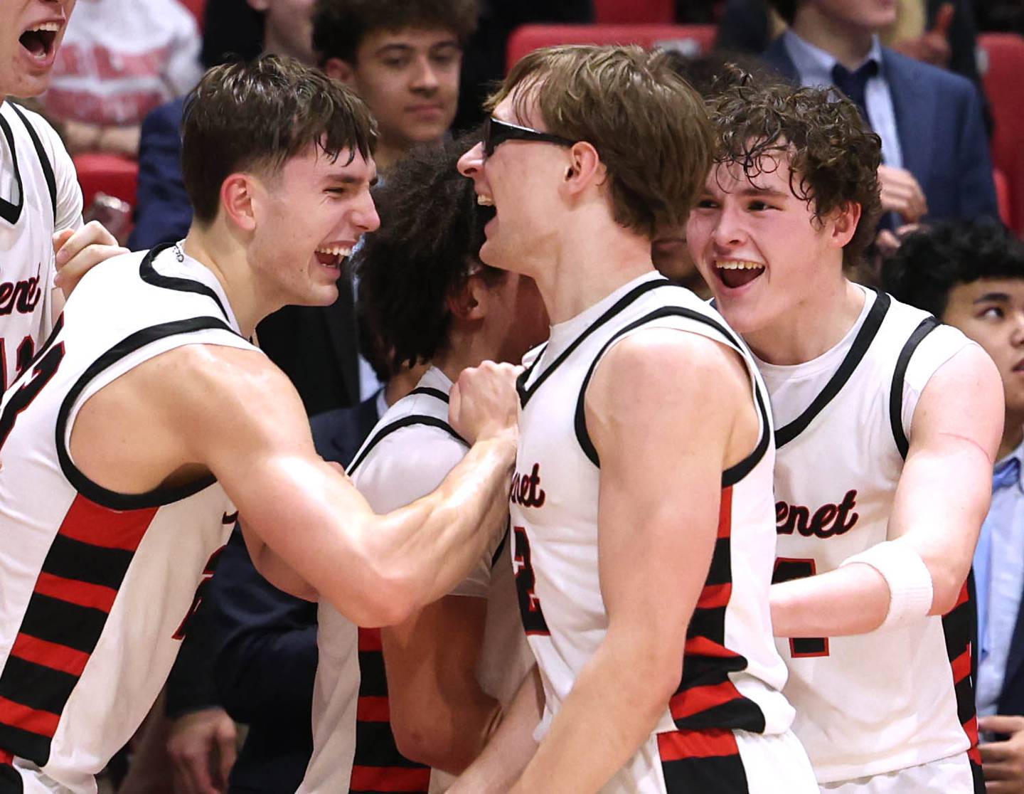 Benet players celebrate after their win Monday, March 9, 2026, in their IHSA Class 4A supersectional win over Auburn in the Convocation Center at Northern Illinois University in DeKalb.