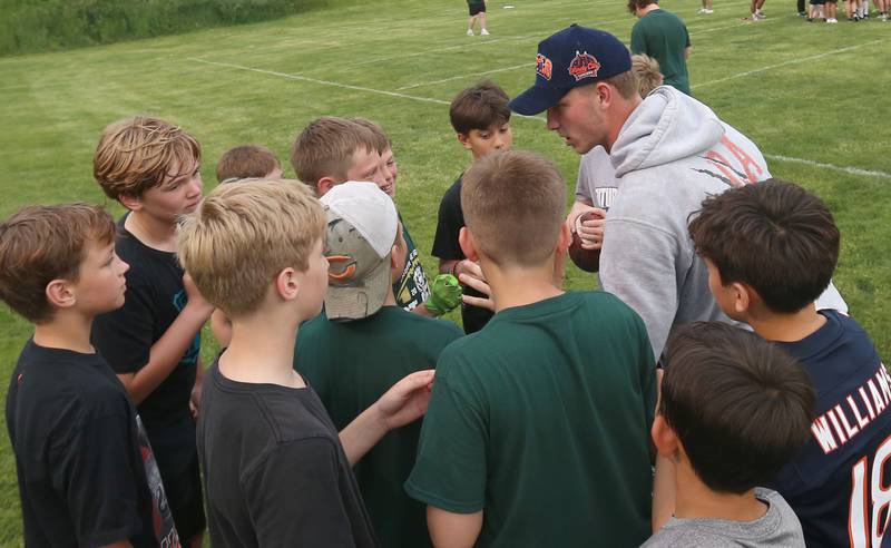 Chicago Bears quarterback Tyson Bagent huddles with a group of kids during the Tyson Bagent Offensive Skills Camp on Saturday, May 23, 2026 at St Bede Academy.