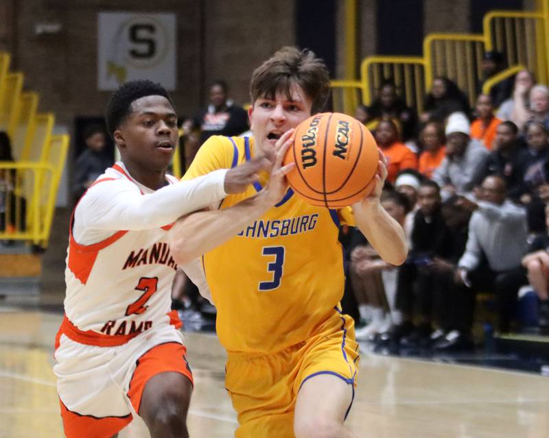 Johnsburg’s Trey Toussaint, right, races to the net against Peoria Manual’s Tahj Tolliver in boys IHSA Class 2A Supersectional basketball on Monday, Mar. 9, 2026, at Sterling High School in Sterling.