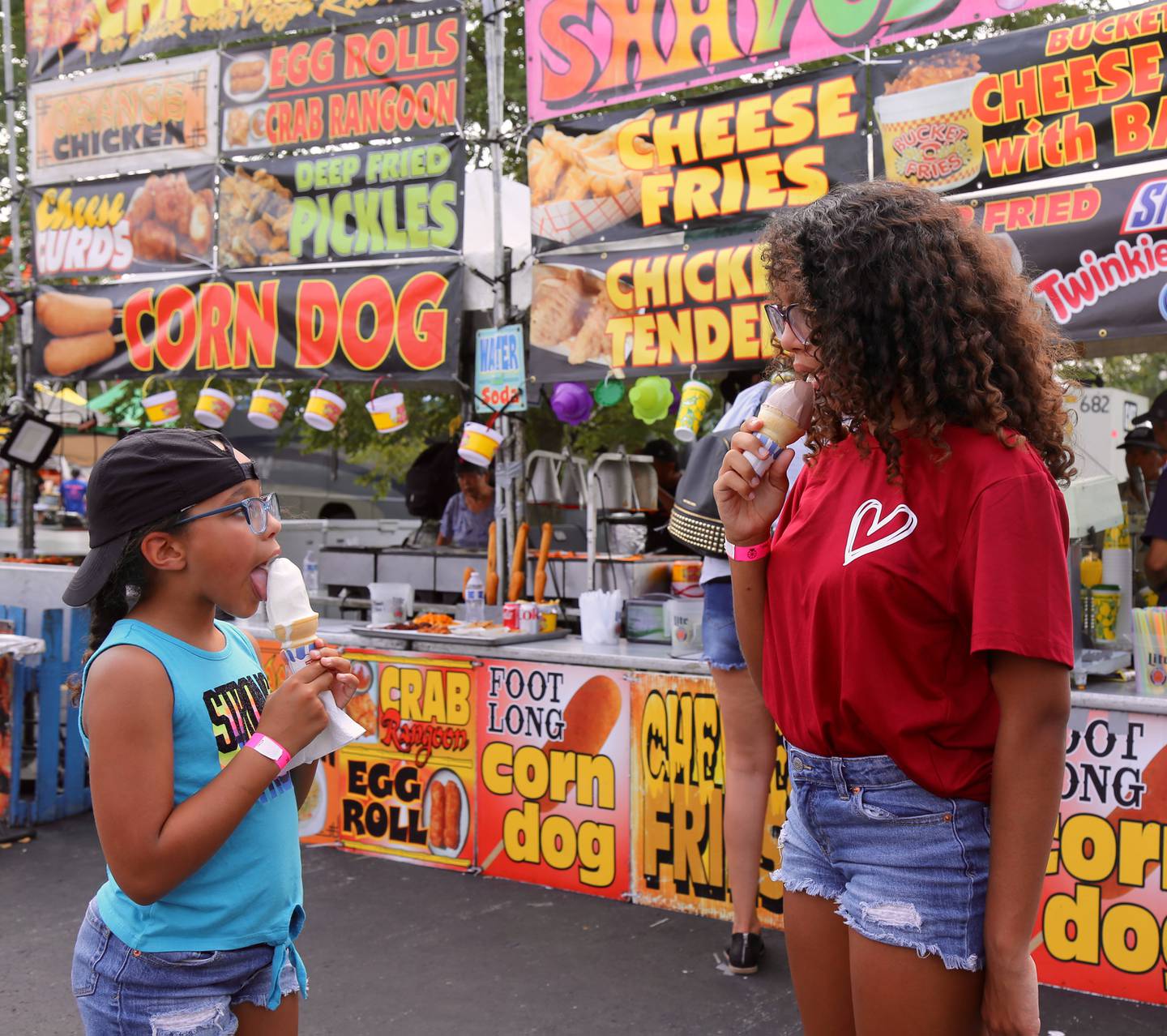 Taylor (8) and Breanna (12) Glover of Aurora, enjoy ice cream cones at the Sugar Grove Corn Boil on Saturday, July 22, 2023 in Sugar Grove.