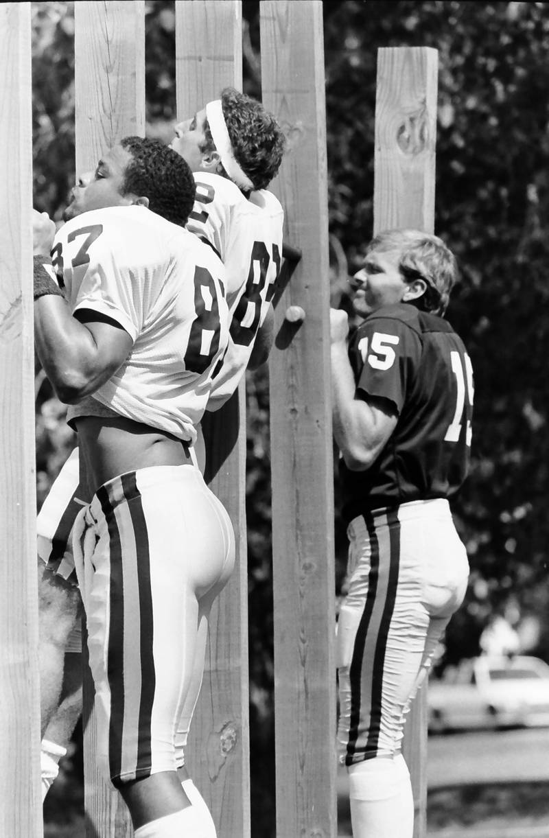 Chicago Bears players (from left) Emery Moorehead, Willie Gault and Dave Finser, work on pullups before practice during training camp on Wednesday, June 12, 1985 in Platteville Wis. Players would have to do five pullups and run two-laps before every practice.