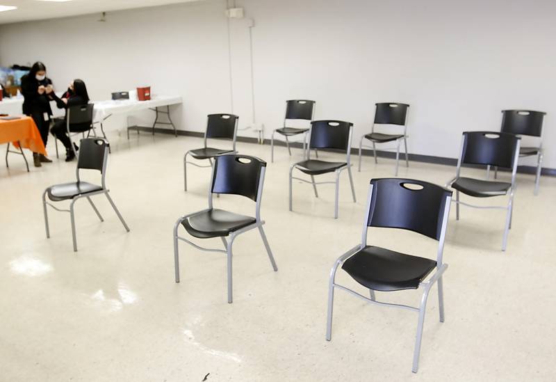 With empty chairs filling the room nurses wait for people at a Covid-19 vaccination clinic Monday, Jan. 24, 2022, at the Algonquin Township office, 3702 Route 14 in Crystal Lake. The clinic was put on by the township to help people get they vaccine, after the Omicron variant made getting shots at other locations harder. Illinois