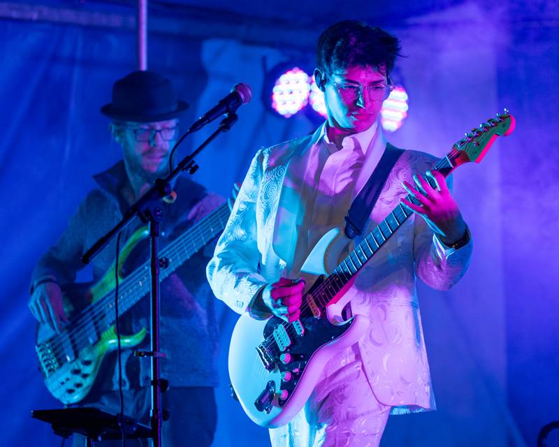 (from left) Kyle Buffo of Harmonix flicks Bass Guitar as bandmate Timmy Campbell strums guitar during the band's performance at Frosty on First on Friday, November 7, 2025 on First Street in La Salle.