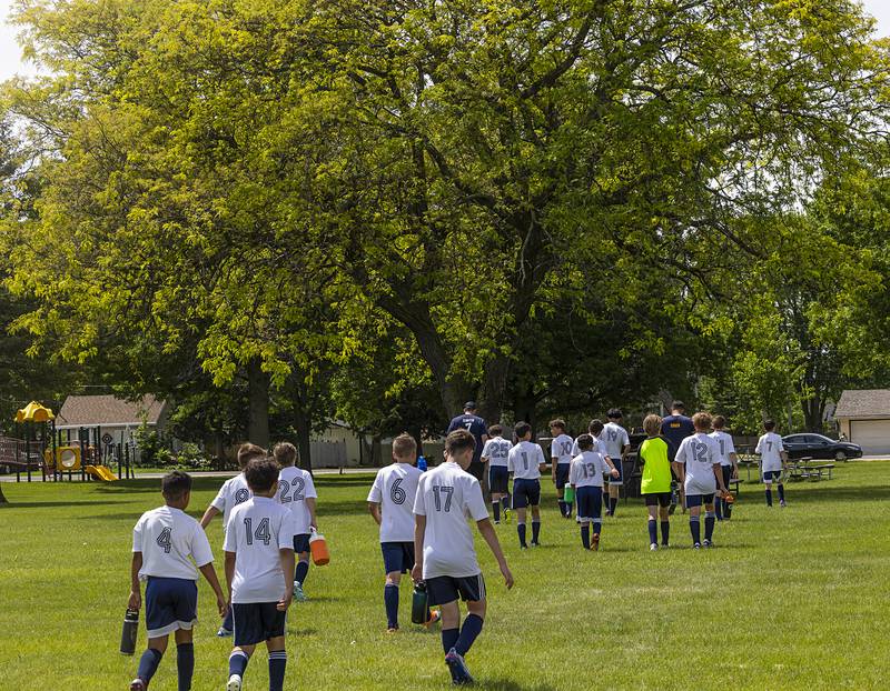 The Sterling United soccer U12 team heads for some shade at half time Sunday, May 19, 2024 at Scheid Park in Sterling.
