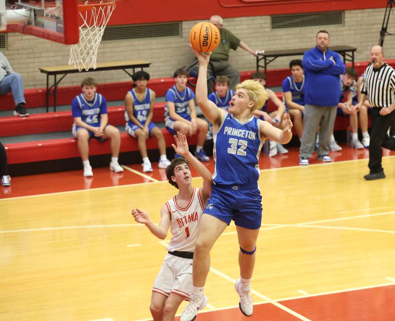 Princeton's Owen Hartman lets to of the ball on a layup as Ottawa's Colt Bryson defends during the Dean Riley Shootin' The Rock Thanksgiving Tournament on Monday Nov. 24, 2025 in Kingman Gymnasium at Ottawa High School.