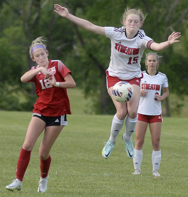 Streator's Bella Dean (15) collects a ball out of the air in front of Metamora's Emmie Graf (12) and Streator's Joey Puetz (3) Friday, May 19, 2023, during the championship match of the Class 2A Streator Regional at the Streator Family YMCA.