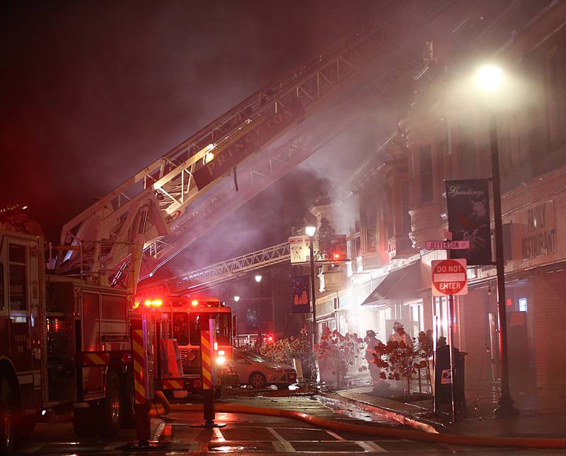 Firefighters extinguish flames from a second story apartment at 708 Illinois Avenue on Friday, Dec. 30, 2022 downtown Mendota.