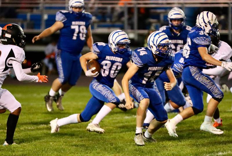 Princeton's Casey Etheridge runs the ball against Kewanee Friday night.