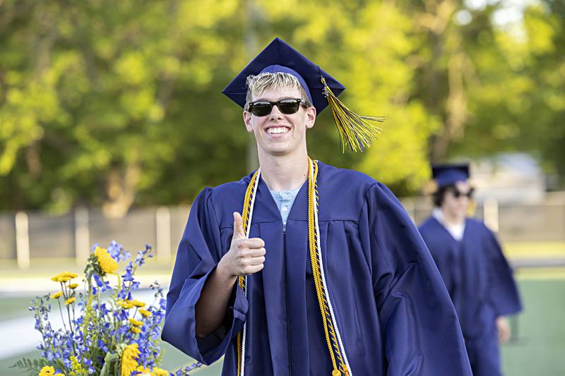 Hunter Lofgren gives a thumbs up after walking across the stage to collect his diploma from Sterling High School Friday, May 26, 2023.