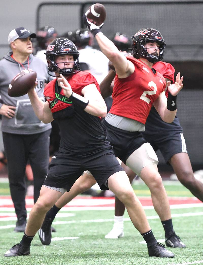Northern Illinois quarterbacks Nevan Cremascoli (left) and Ethan Hampton throw passes during the teams first spring practice Wednesday, March 22, 2023, in the Chessick Practice Center at Northern Illinois University in DeKalb.