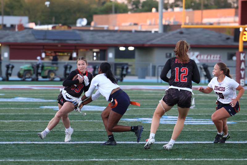Yorkville's Mackenna Fousek runs the ball as Oswego's Jazmin Hurston grabs her flag during the Foxes' 2-1 overtime victory over Oswego in the IHSA Kankakee Regional championship game on Thursday, Oct. 9, 2025.