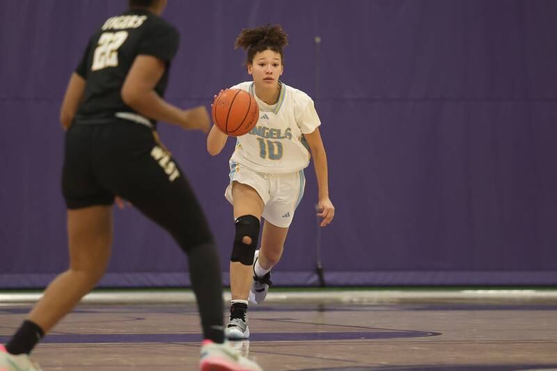 Joliet Catholic’s deAnna Cooley takes the ball upcourt against Joliet West in the 2023 WJOL Girls Basketball Tournament on Friday, Nov. 17, 2023, in Joliet