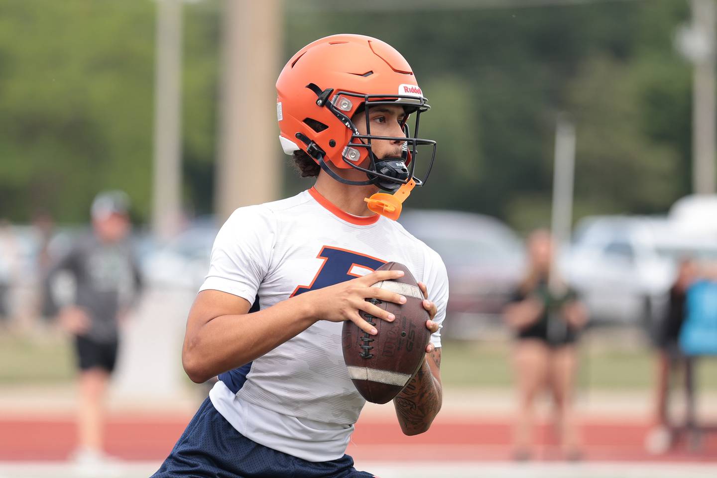 Romeoville's Richard Conley looks to pass against Plainfield Central at Morris' 7-on-7 scrimmage on Tuesday, July 8, 2025 in Morris.