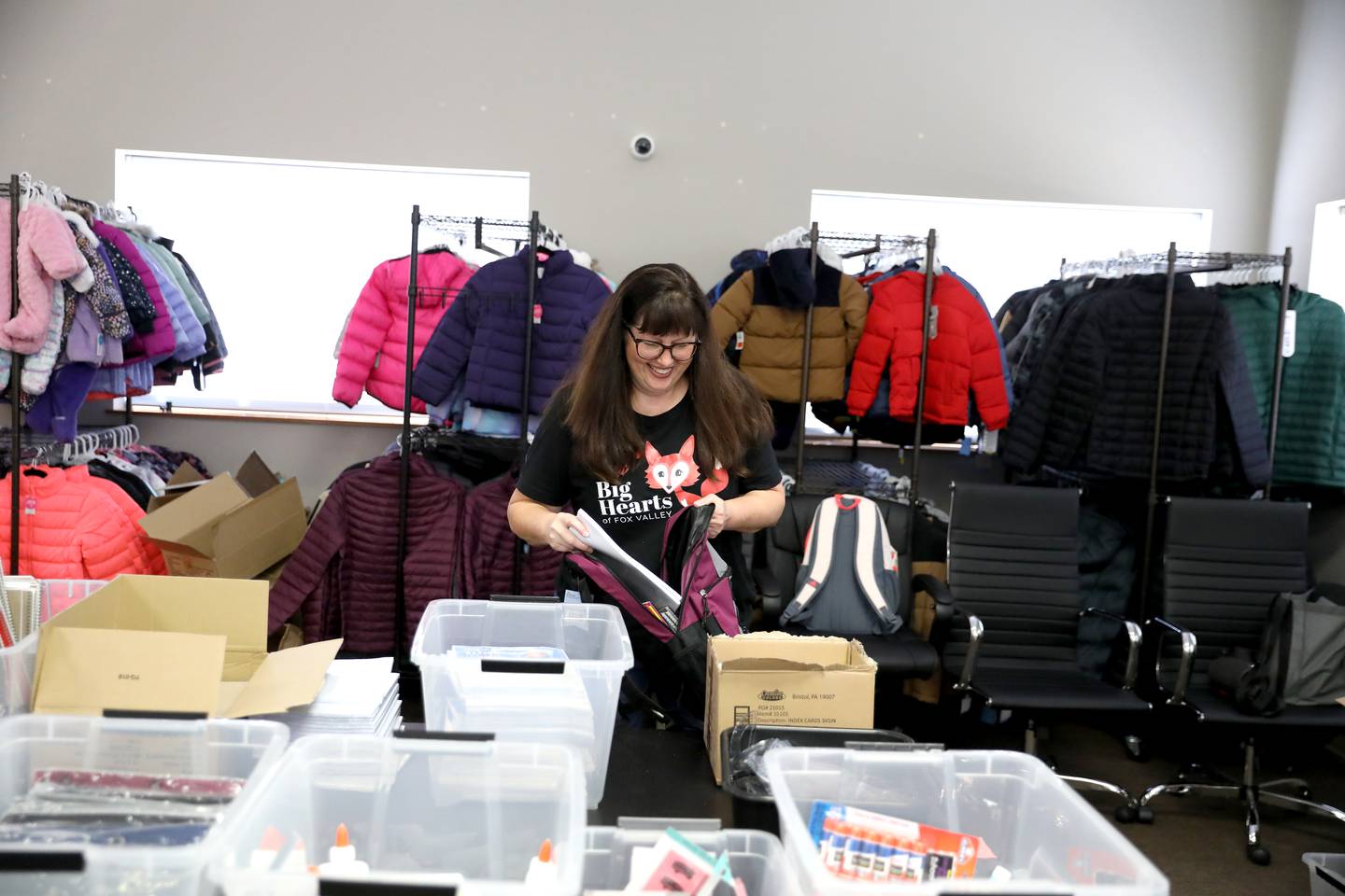Julie Garthwaite, Big Hearts of Fox Valley board member and back-to-school program chairperson, fills backpacks with everything middle and high school students in St. Charles School District 303 will need for the upcoming school year.