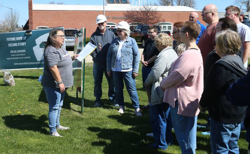 Julie Grady, (left) chair of the building committee, speaks to volunteers and supports at the new Second Story Teen Center during the groundbreaking ceremony on Saturday, April 13, 2024 in Princeton.