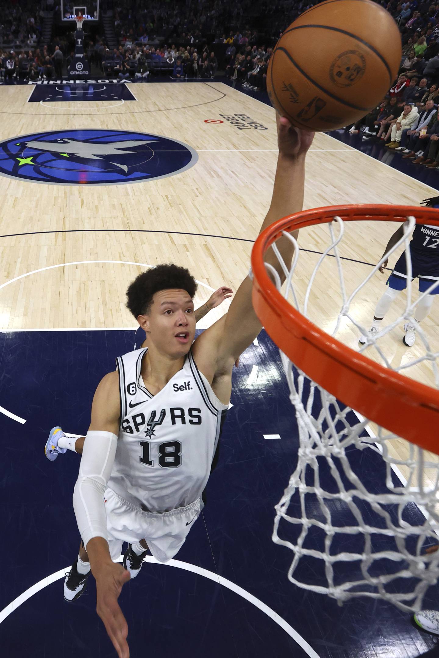 San Antonio Spurs forward Isaiah Roby (18) goes up for a shot during the first half of an NBA basketball game against the Minnesota Timberwolves, Wednesday, Oct. 26, 2022, in Minneapolis. (AP Photo/Abbie Parr)