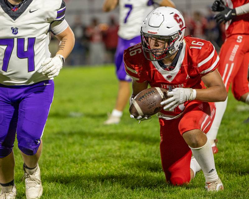 Demarcus Hunter (16) of Streator holds ball whilst kneeling after being tackled in game against Dixon on Friday, October 17, 2025 at Streator High School in Streator.