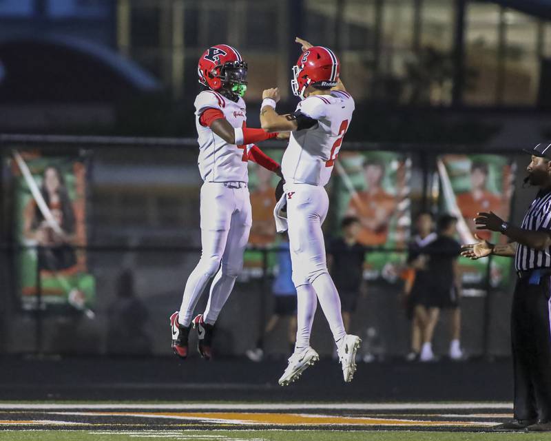 Yorkville's Jayden Ruth (4) celebrates his touchdown run after a short catch from Jack Beetham (2) during football game between Yorkville at Plainfield East Friday, Sept 19, 2025 in Plainfield.
