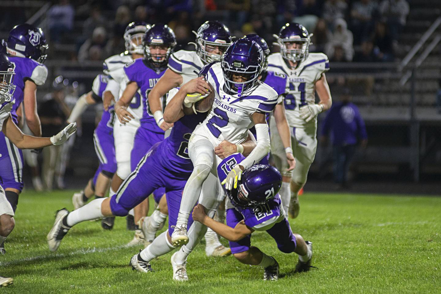 Dixon’s Aiden Wiseman (left) and Tyson Dambman take down Rockford Lutheran’s David Ballard Friday, Sept. 30, 2022.