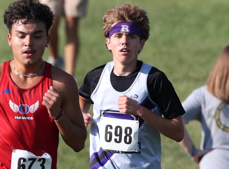 Rochelle’s Tyler Johnson (right) keeps pace with other runners Tuesday, Sept. 2, 2025, during the Sycamore Cross Country Invitational at Northern Illinois University in DeKalb.