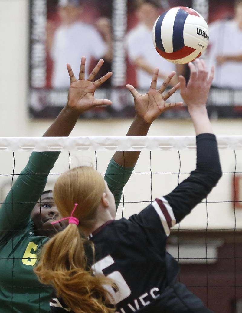 Crystal Lake South's Sahara Okirika  tries to block the spike of Prairie Ridge's Sonora Bekere during the IHSA Class 3A Prairie Ridge Regional championship volleyball match on Thursday, Oct. 30, 2025, at the Prairie Ridge High School in Crystal Lake.